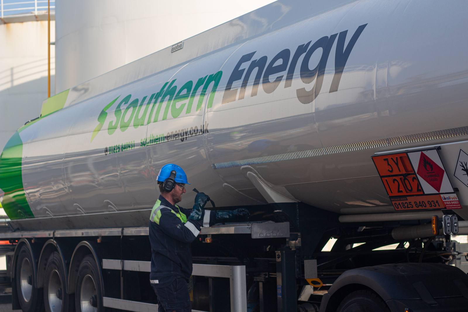 Southern Energy tanker at a fuel terminal, with a worker in a hard hat beside the trailer