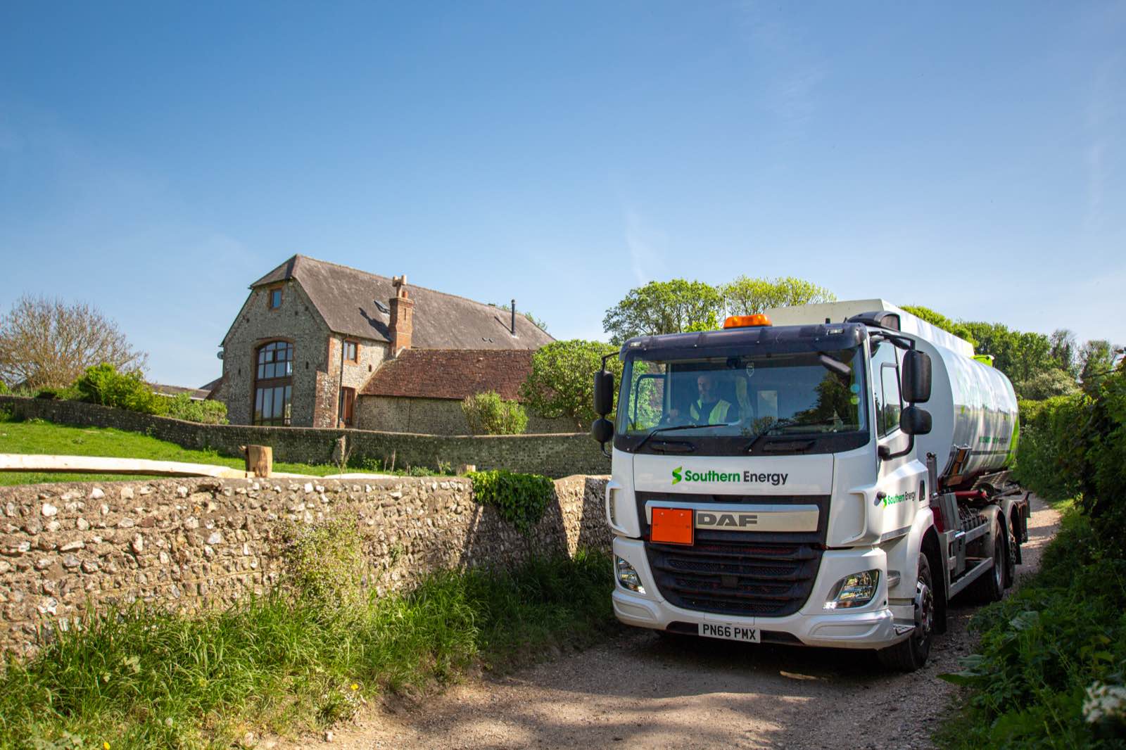 Heating oil tanker delivering to a family home