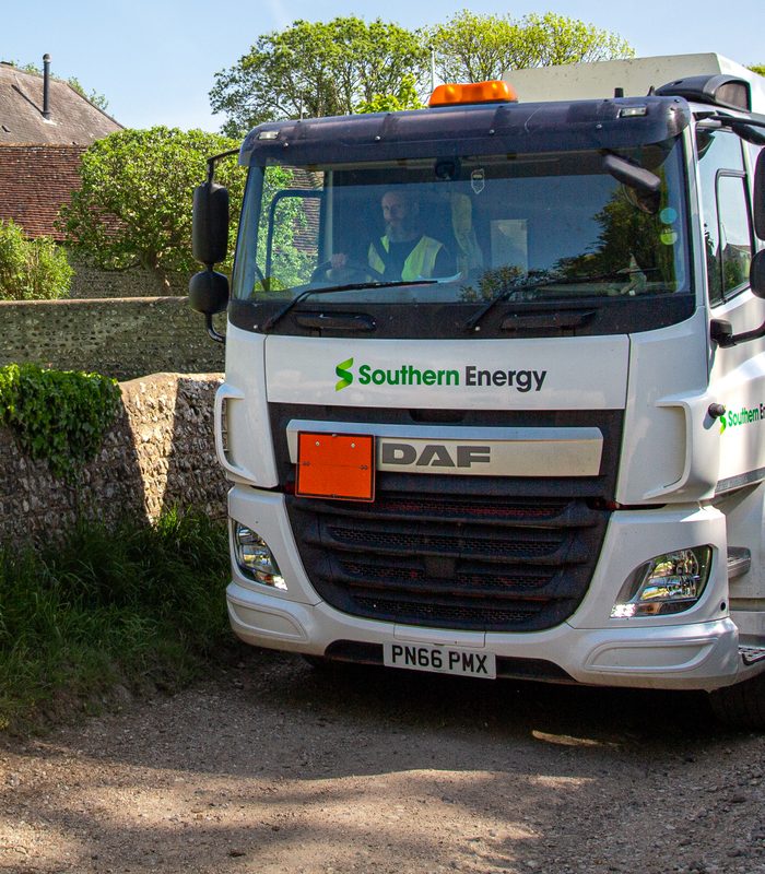 Heating oil tanker delivering to a family home