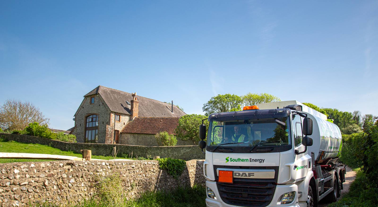 Heating oil tanker delivering to a family home