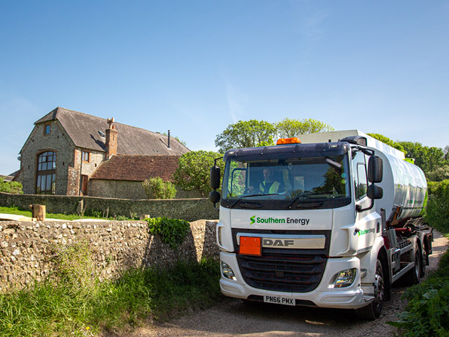 Heating oil tanker delivering to a family home